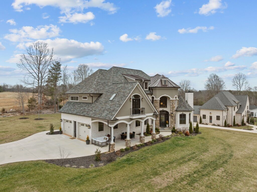 The French Chateau by WOLFE: aerial view of the front exterior and driveway